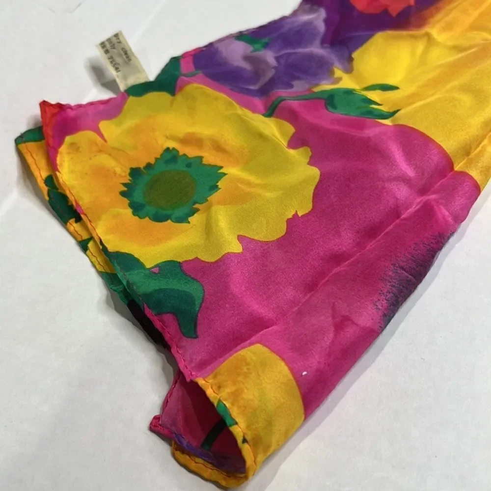Vibrant floral silk scarf with gold purple pink and red flowers.